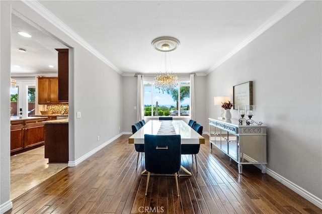 40493 Calle Katerine, Temecula, CA 92591 - dining area featuring a chandelier, dark wood-style floors, ornamental molding, and baseboards