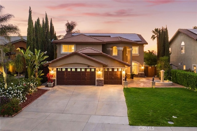 40493 Calle Katerine, Temecula, CA 92591 - mediterranean / spanish-style home with a yard, solar panels, concrete driveway, stucco siding, and an attached garage