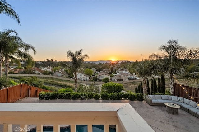 40493 Calle Katerine, Temecula, CA 92591 - patio terrace at dusk with an outdoor living space with a fire pit, a residential view, and fence