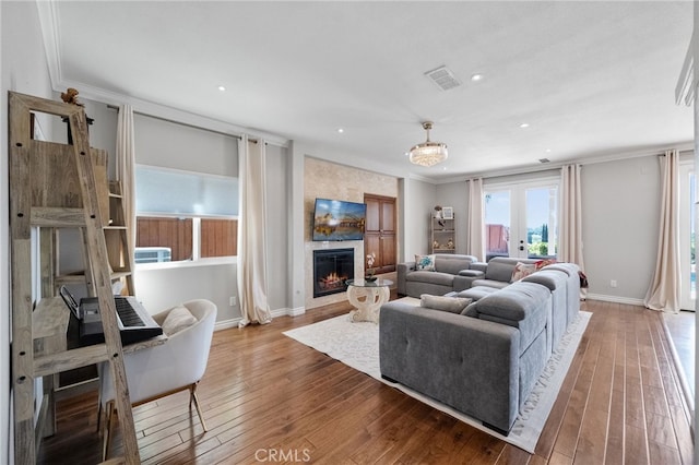 40493 Calle Katerine, Temecula, CA 92591 - living area with a large fireplace, hardwood / wood-style floors, ornamental molding, baseboards, and recessed lighting