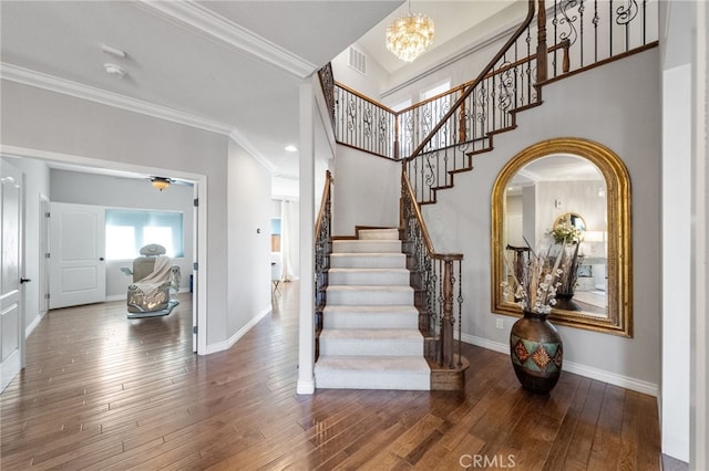 40493 Calle Katerine, Temecula, CA 92591 - entrance foyer with ornamental molding, stairway, baseboards, wood-type flooring, and a chandelier