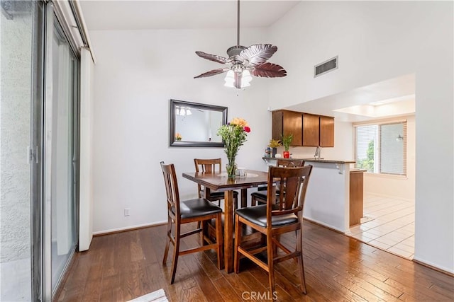 38970 Paseo De Oro, Murrieta, CA 92563 - dining room with dark wood-style floors, a ceiling fan, a towering ceiling, and baseboards