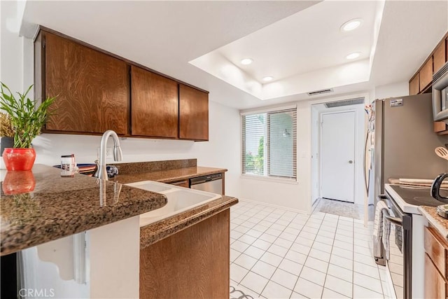 38970 Paseo De Oro, Murrieta, CA 92563 - kitchen with electric stove, dishwasher, light tile patterned floors, brown cabinets, and recessed lighting