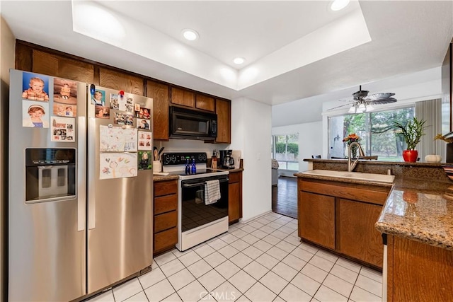 38970 Paseo De Oro, Murrieta, CA 92563 - kitchen with stainless steel fridge, range with electric cooktop, black microwave, a sink, and a tray ceiling