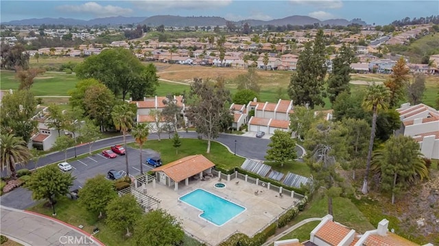 38970 Paseo De Oro, Murrieta, CA 92563 - aerial overview of property's location featuring a pool area, nearby suburban area, and a mountainous background