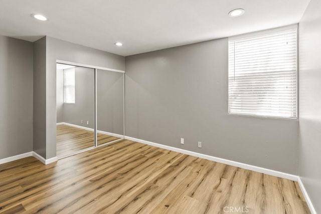 18620 Hatteras St Unit 223, Tarzana, CA 91356 - unfurnished bedroom with baseboards, wood finished floors, a closet, and recessed lighting