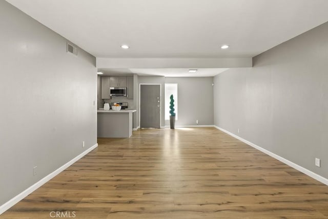 18620 Hatteras St Unit 223, Tarzana, CA 91356 - unfurnished living room featuring baseboards, recessed lighting, and wood finished floors