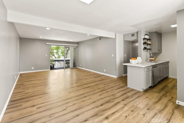 18620 Hatteras St Unit 223, Tarzana, CA 91356 - kitchen with gray cabinets, a sink, light countertops, light wood finished floors, and open shelves