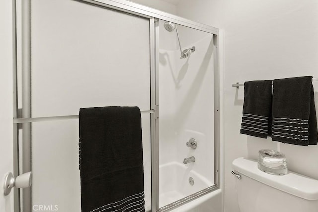 full bath featuring shower / bath combination with glass door and toilet