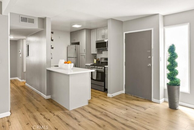 18620 Hatteras St Unit 223, Tarzana, CA 91356 - kitchen featuring stainless steel appliances, light wood-style floors, light countertops, and baseboards