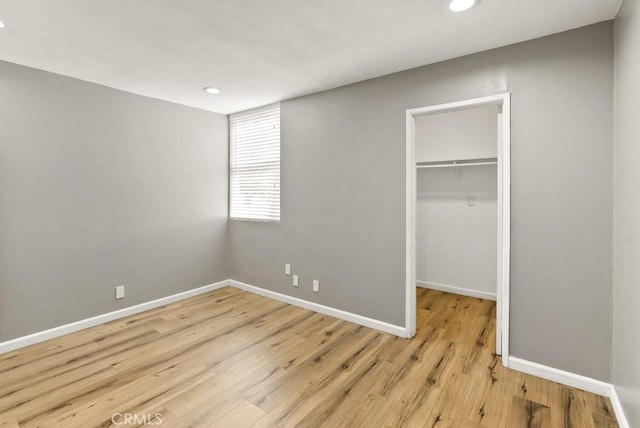 18620 Hatteras St Unit 223, Tarzana, CA 91356 - unfurnished bedroom featuring a walk in closet, recessed lighting, light wood finished floors, and baseboards