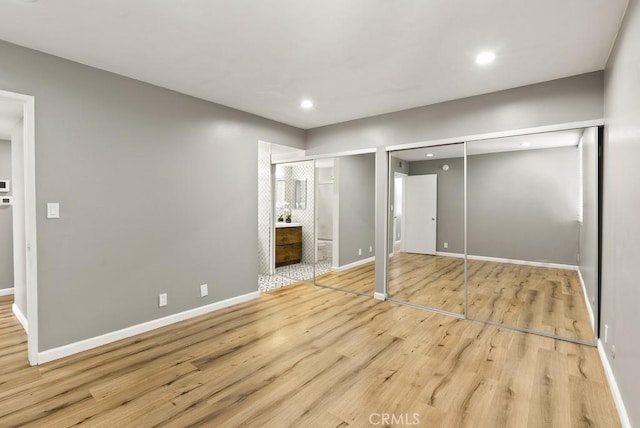 18620 Hatteras St Unit 223, Tarzana, CA 91356 - unfurnished bedroom featuring wood finished floors, recessed lighting, two closets, baseboards, and ensuite bathroom