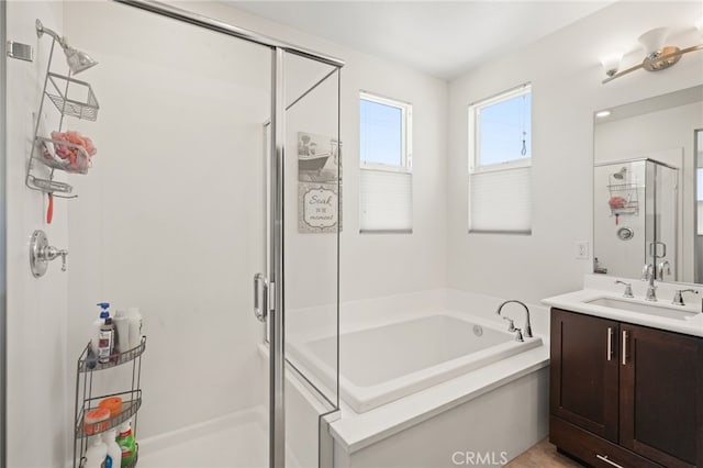 full bath featuring a shower stall, a bath, and vanity