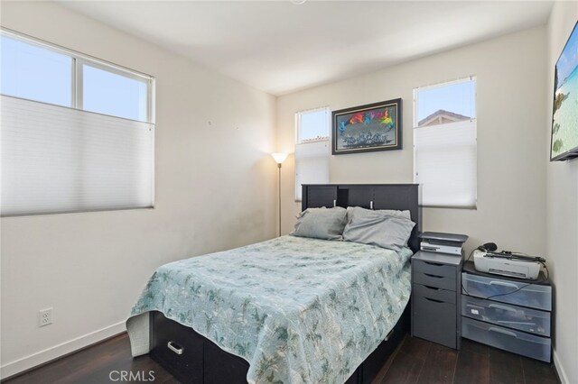 bedroom featuring dark wood-type flooring and baseboards