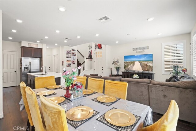 dining area with stairway, recessed lighting, and dark wood-type flooring