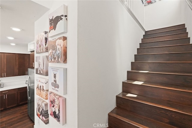 stairway featuring wood finished floors