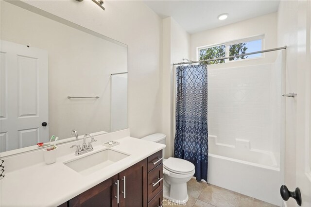 bathroom featuring toilet, vanity, shower / bath combo, and tile patterned floors