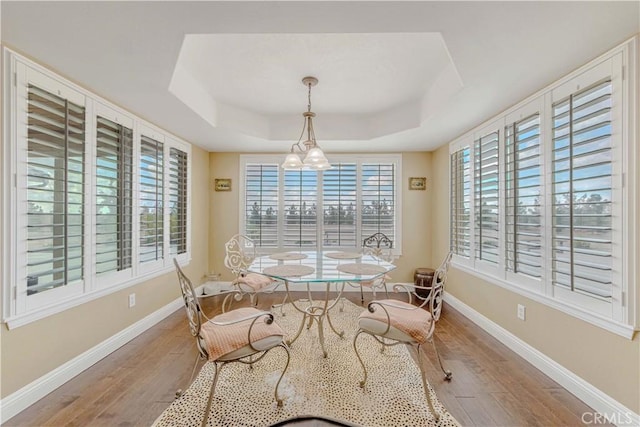 4428 Trumbo Ct, Phelan, CA 92371 - dining room featuring a tray ceiling, wood finished floors, baseboards, and a chandelier