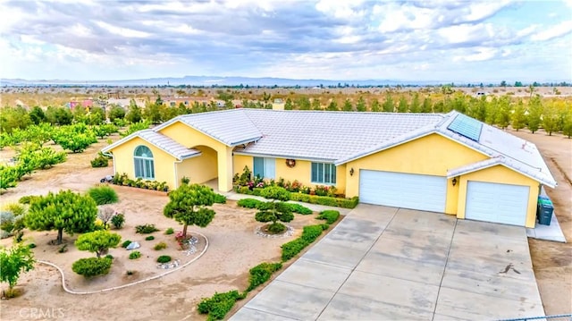 4428 Trumbo Ct, Phelan, CA 92371 - single story home featuring a garage, concrete driveway, a tiled roof, stucco siding, and a chimney