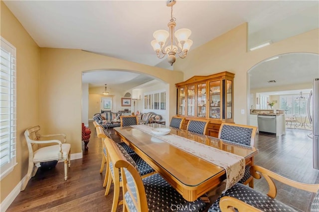 4428 Trumbo Ct, Phelan, CA 92371 - dining area featuring arched walkways, dark wood finished floors, a chandelier, and baseboards
