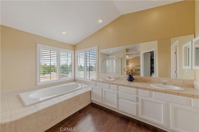 4428 Trumbo Ct, Phelan, CA 92371 - full bath featuring vaulted ceiling, wood finished floors, a bath, a shower stall, and double vanity