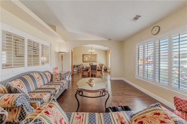 4428 Trumbo Ct, Phelan, CA 92371 - living area featuring arched walkways, baseboards, wood finished floors, and a chandelier