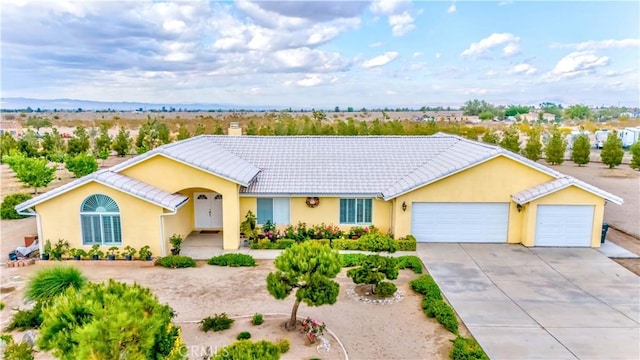 4428 Trumbo Ct, Phelan, CA 92371 - ranch-style home with a garage, driveway, a tiled roof, and stucco siding