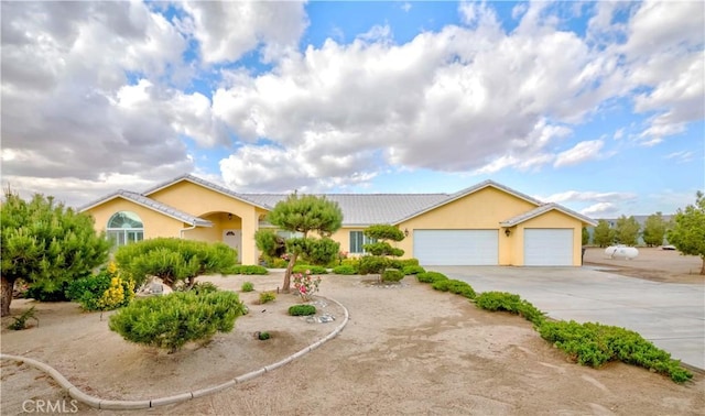 4428 Trumbo Ct, Phelan, CA 92371 - ranch-style home with an attached garage, driveway, stucco siding, and a tiled roof
