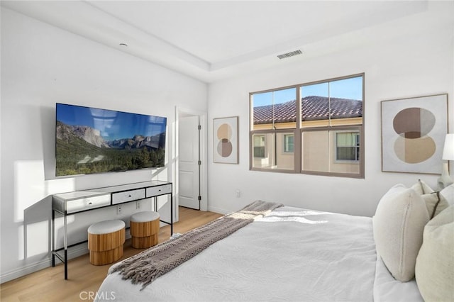bedroom featuring wood finished floors and baseboards