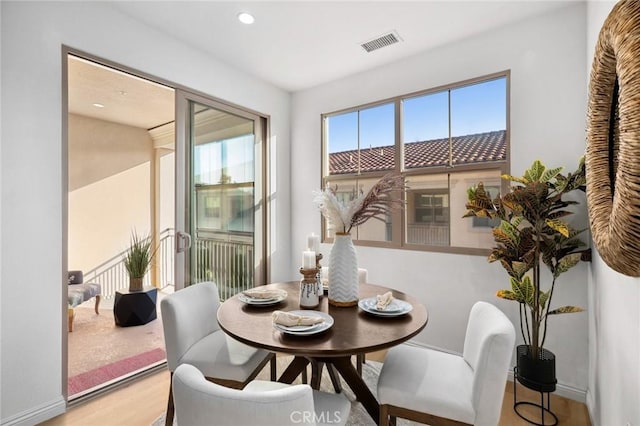 dining room with light wood-type flooring, baseboards, and recessed lighting