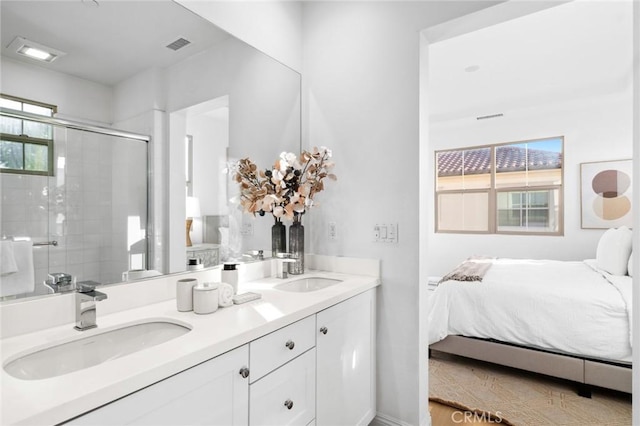 ensuite bathroom with a shower stall and double vanity