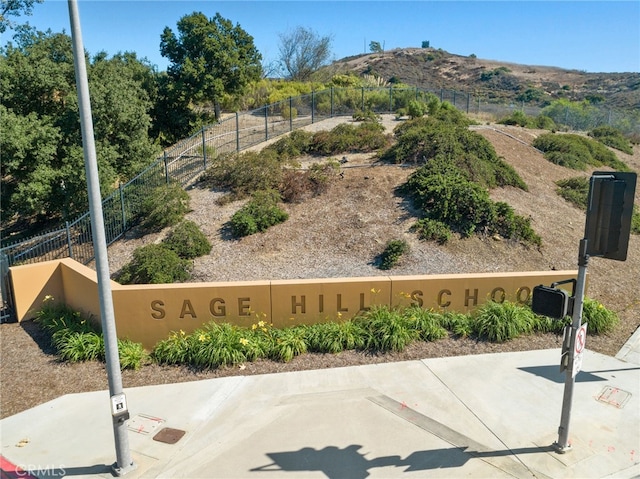 view of community featuring fence and a mountain view