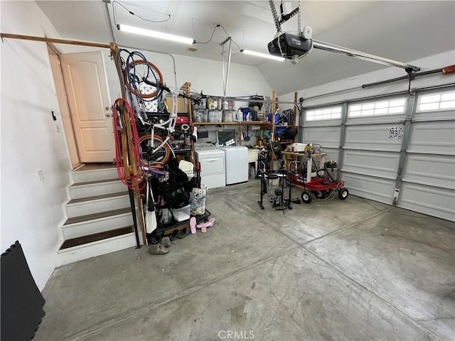 garage with a garage door opener and separate washer and dryer