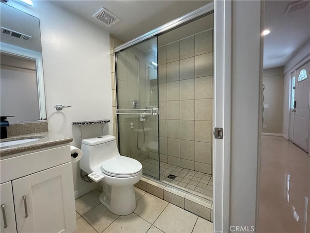 full bath with tile patterned flooring, toilet, a stall shower, and vanity