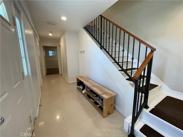 stairs with tile patterned flooring, baseboards, and recessed lighting