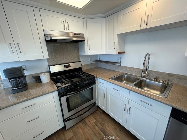 kitchen with appliances with stainless steel finishes, under cabinet range hood, a sink, dark wood-type flooring, and white cabinetry
