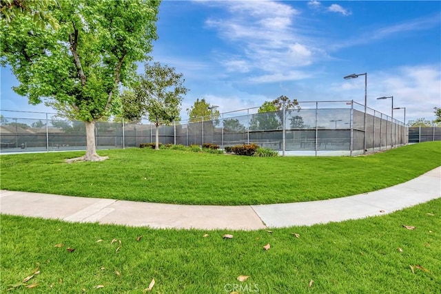 view of property's community featuring a tennis court