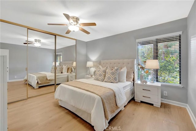bedroom featuring light wood-style floors, baseboards, a closet, and a ceiling fan