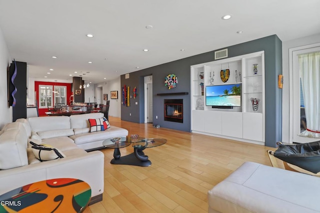1524 Seabridge Ln, Oxnard, CA 93035 - living room with a glass covered fireplace, light wood-style flooring, and recessed lighting
