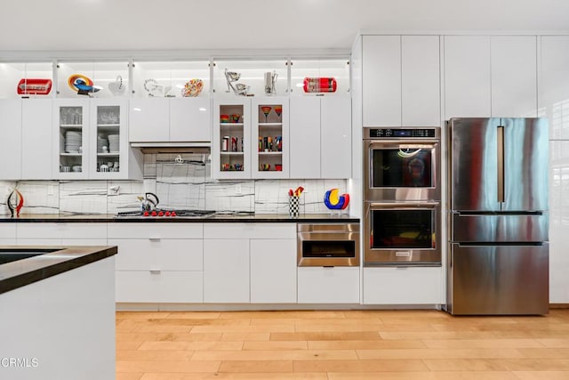 1524 Seabridge Ln, Oxnard, CA 93035 - kitchen with appliances with stainless steel finishes, dark countertops, white cabinets, and tasteful backsplash