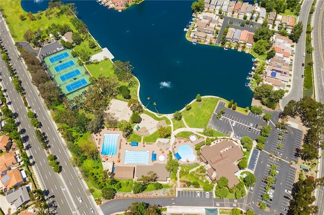 bird's eye view of a nearby body of water and a pool