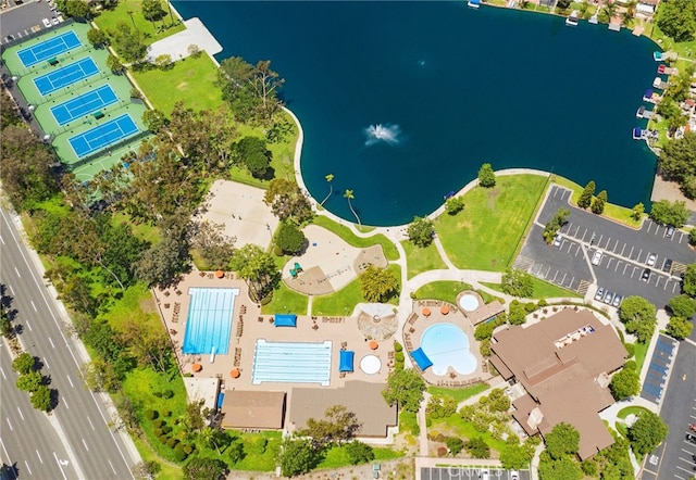 aerial view of a pool area and a large body of water