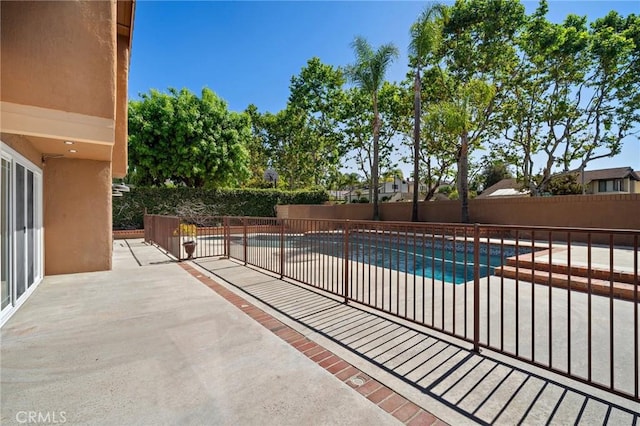 view of pool featuring a patio area and a fenced backyard