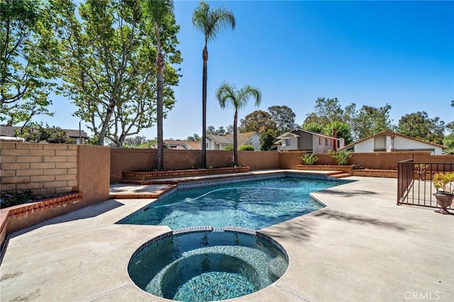 view of pool with a patio area, a fenced backyard, and a pool with connected hot tub