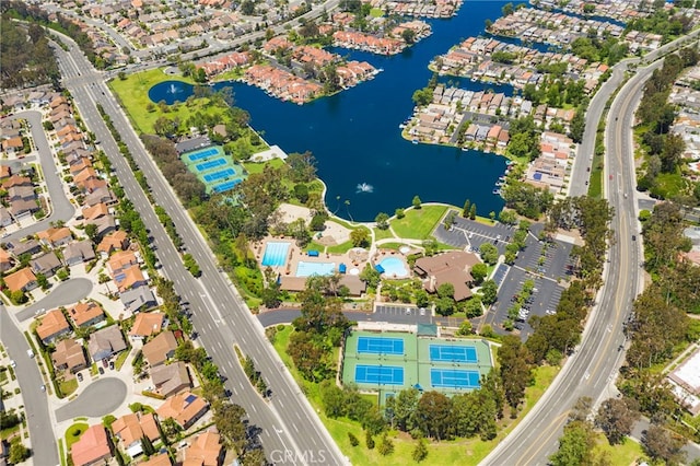 aerial view of residential area featuring a highway and a large body of water