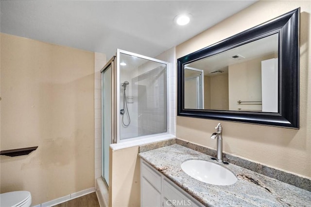 full bath with a shower stall, toilet, vanity, recessed lighting, and wood finished floors