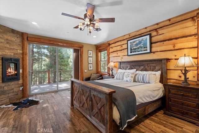 1020 Heritage Trl, Big Bear City, CA 92314 - bedroom featuring access to outside, wood walls, a large fireplace, wood finished floors, and recessed lighting