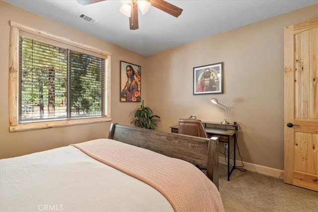 1020 Heritage Trl, Big Bear City, CA 92314 - carpeted bedroom featuring multiple windows, baseboards, and ceiling fan