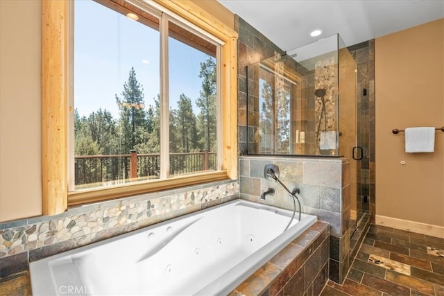 1020 Heritage Trl, Big Bear City, CA 92314 - full bathroom with healthy amount of natural light, a stall shower, a tub with jets, stone tile flooring, and recessed lighting