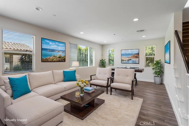 living room featuring baseboards, recessed lighting, wood finished floors, plenty of natural light, and stairway